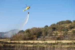 El helicóptero echa agua sobre la zona quemada. JLP.